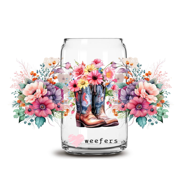 a glass jar with flowers and boots on it