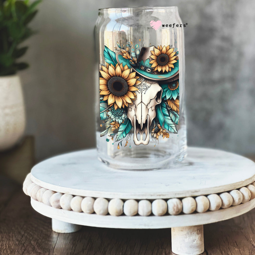 a mason jar with sunflowers and a cow skull on it