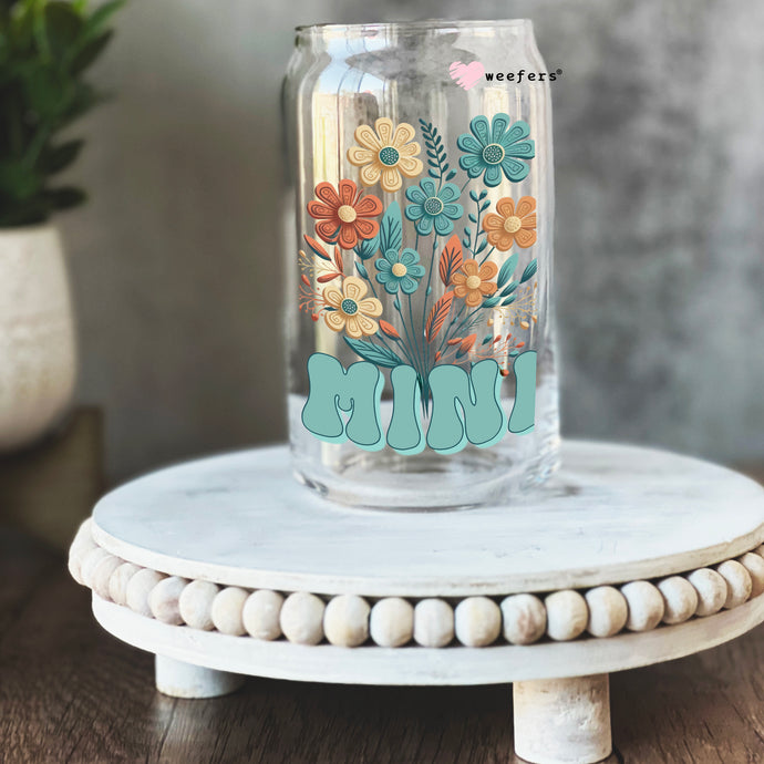 a glass jar with flowers painted on it