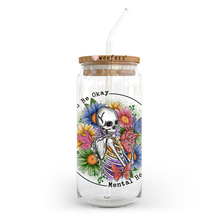 a glass jar with a straw in it with a skeleton on it