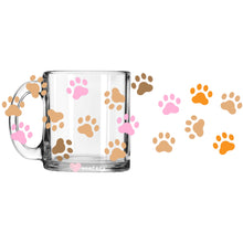 Load image into Gallery viewer, a glass mug with paw prints on it
