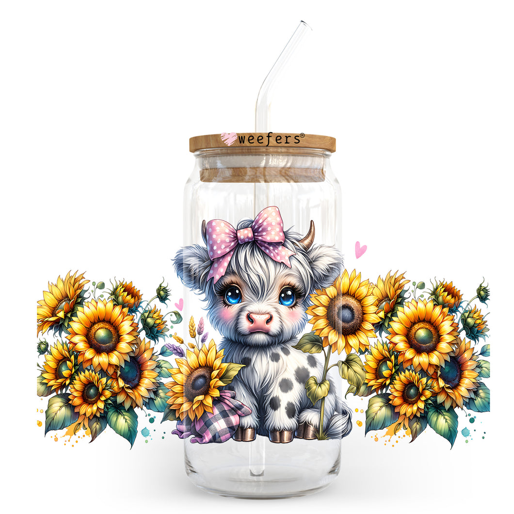 a glass jar with a cow and sunflowers in it