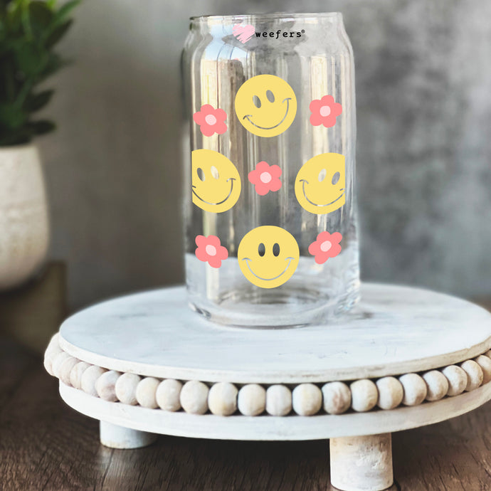 a glass jar with smiley faces painted on it