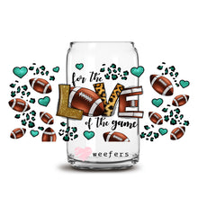 Load image into Gallery viewer, a glass jar filled with footballs and hearts
