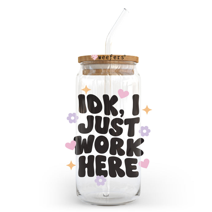 a glass jar with a straw in it that says idk i just work here