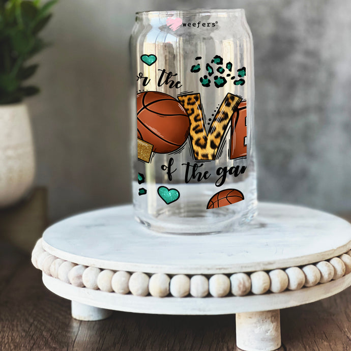 a glass jar with a picture of shoes and a basketball on it