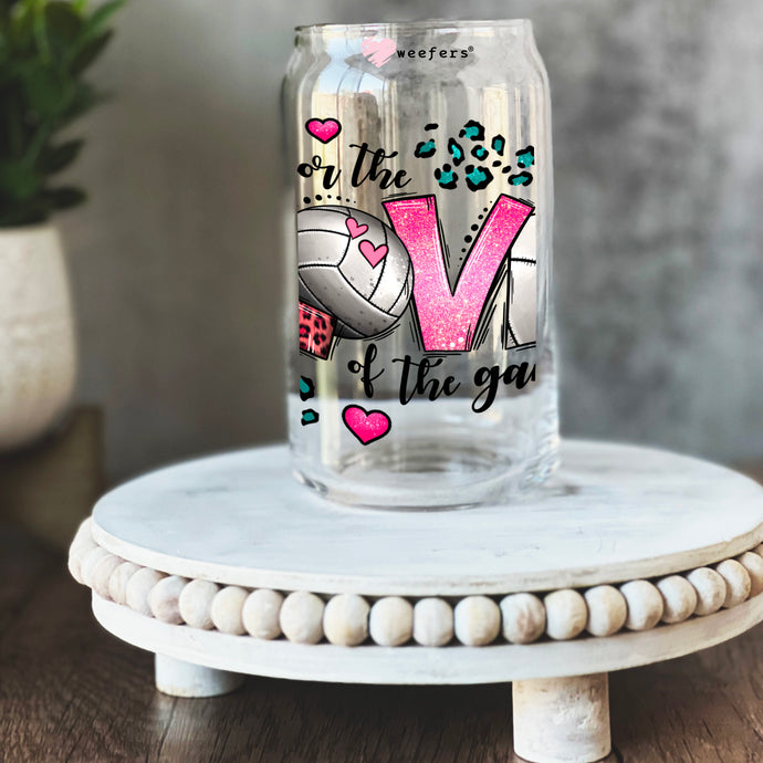 a glass jar with a volleyball design on it