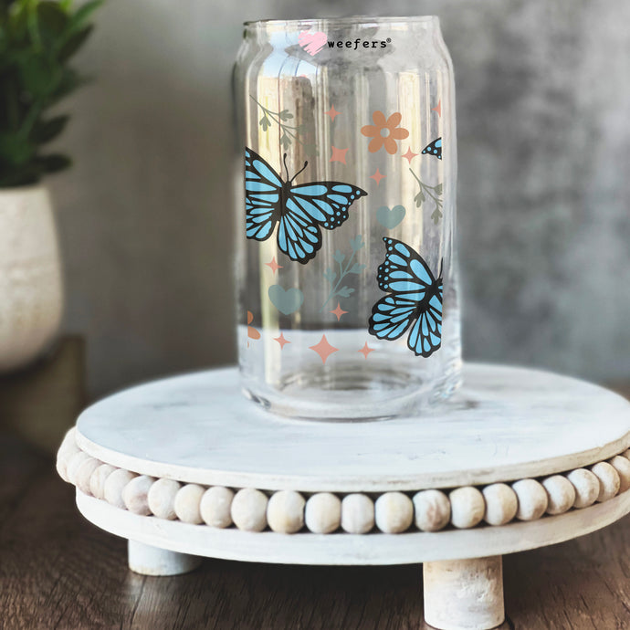 a glass jar with butterflies painted on it