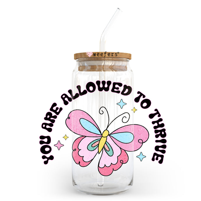 a jar with a straw in it with a butterfly on it