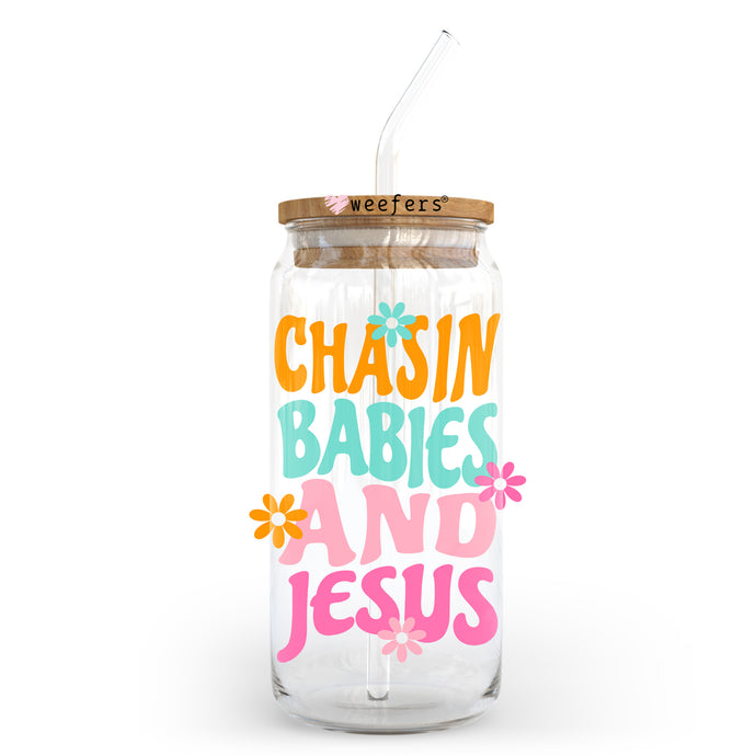 a glass jar with a straw in it that says chasin babies and jesus