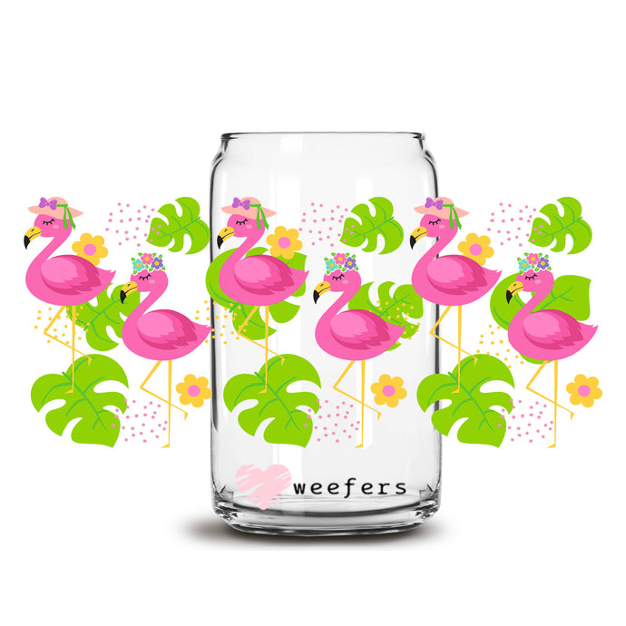 a glass jar filled with pink flamingos and green leaves