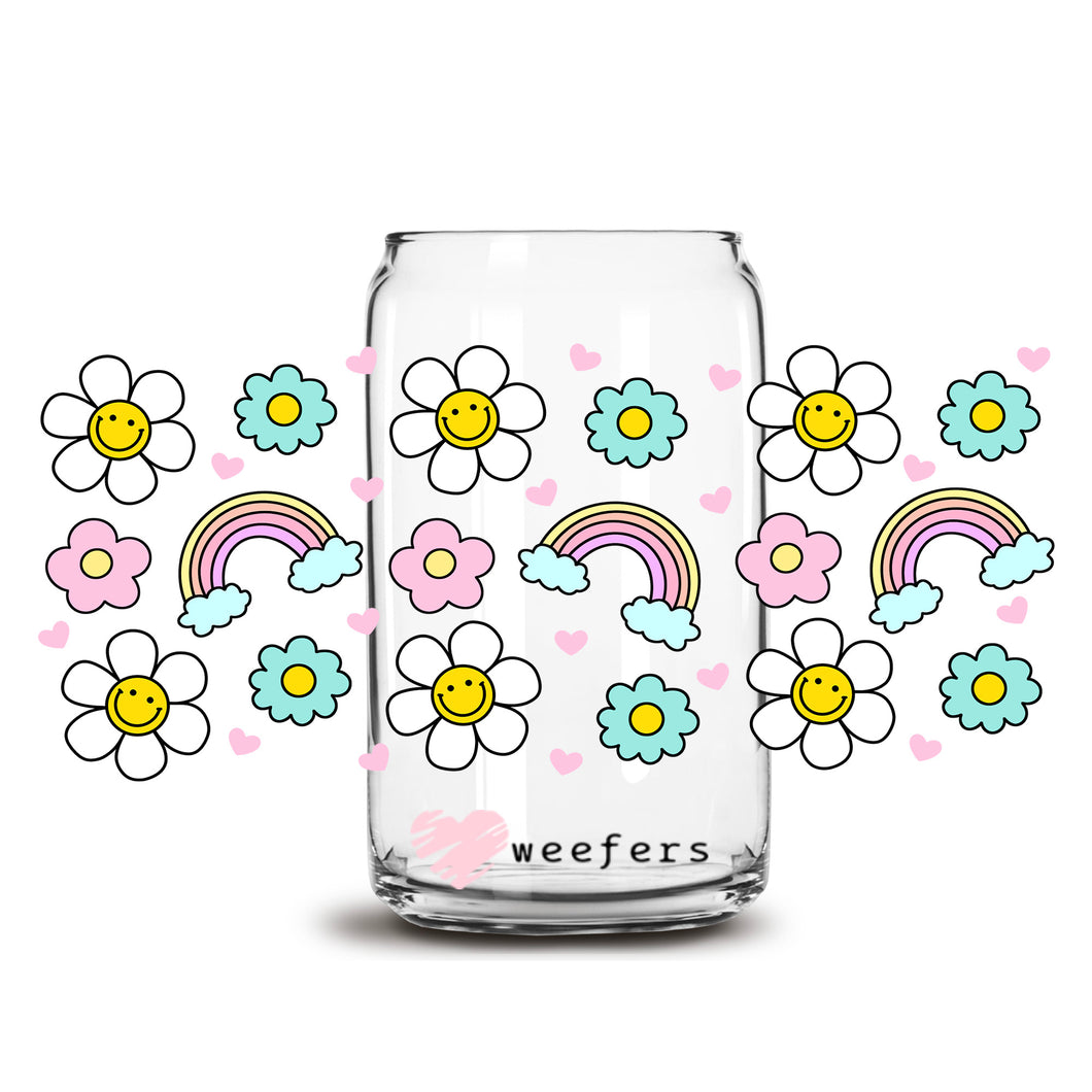 a glass jar with flowers and a rainbow painted on it