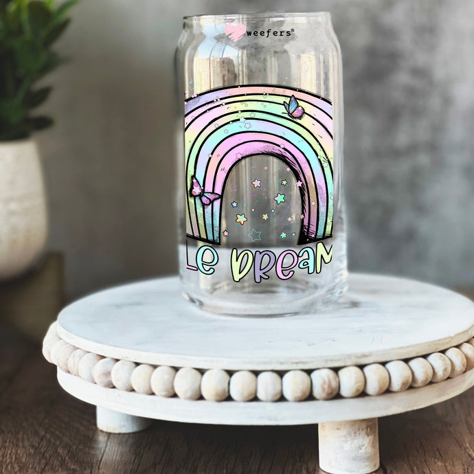 a glass jar with a rainbow painted on it