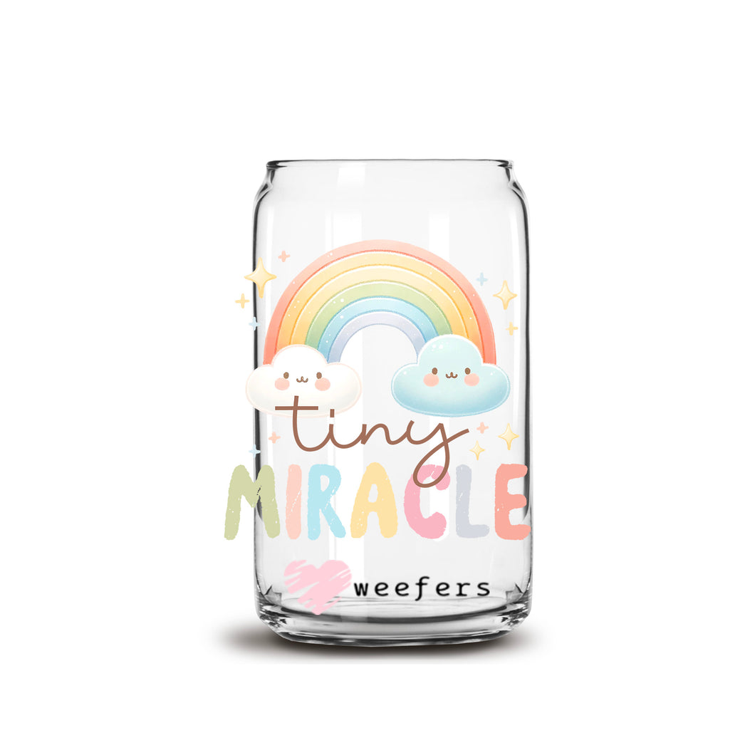 a glass jar with a rainbow and clouds on it