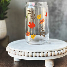 Load image into Gallery viewer, a glass jar with leaves painted on it
