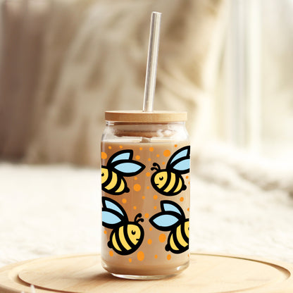 a mason jar with a straw in it with bees on it