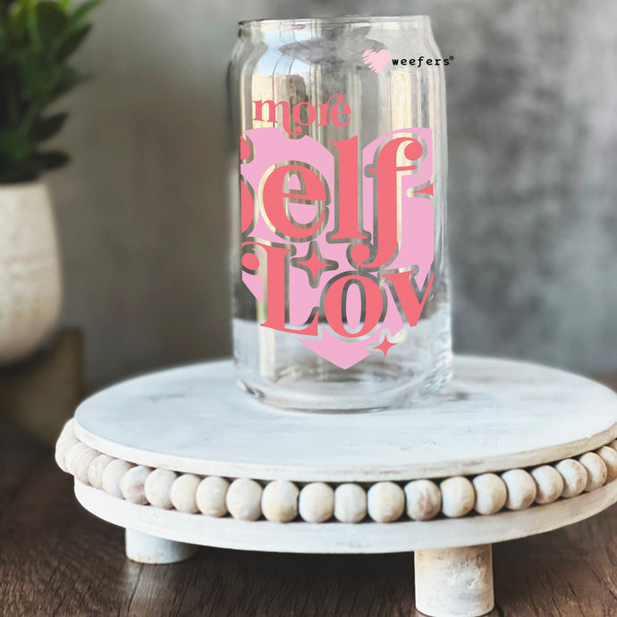 a glass jar with a pink lettering on it