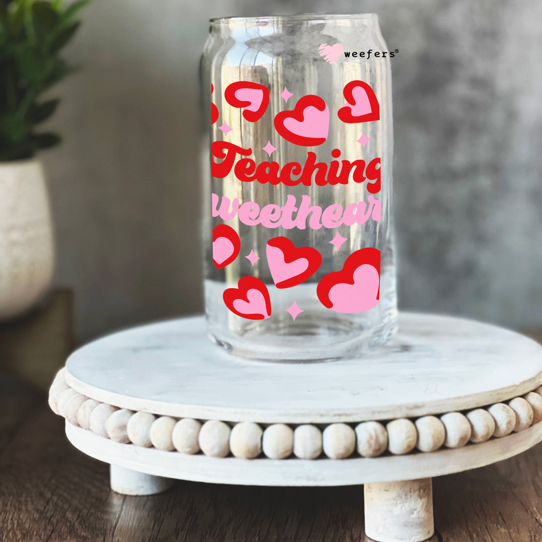 a glass jar with hearts on it sitting on a table