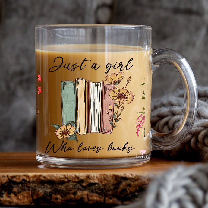 a glass mug with a picture of a book on it