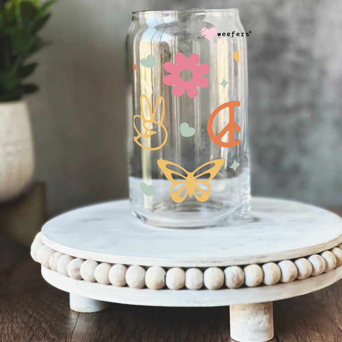 a glass jar with a peace sign painted on it