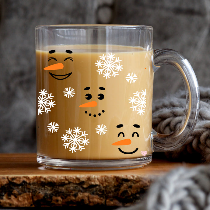 a glass mug with a face drawn on it