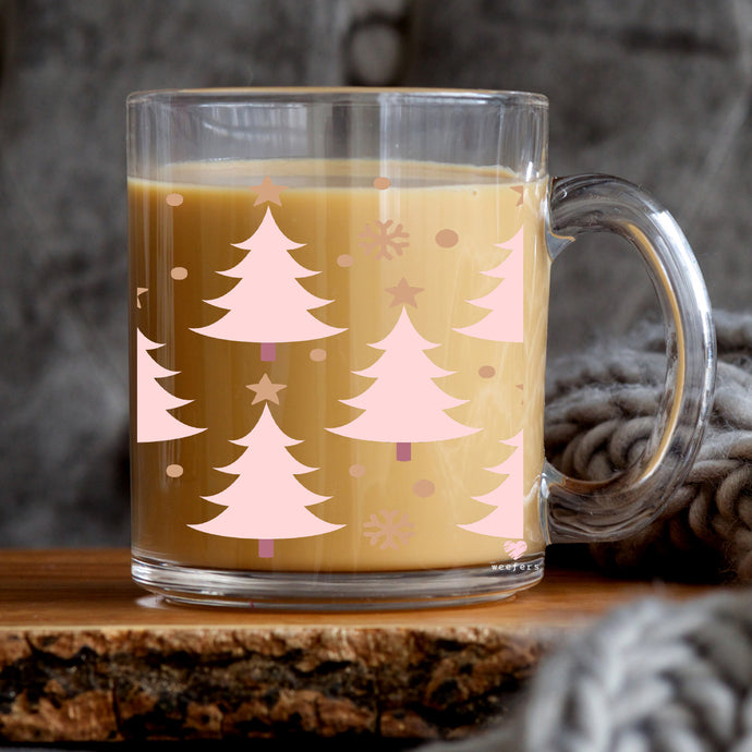 a glass mug with a christmas tree design on it
