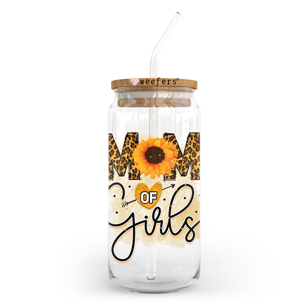 a glass jar with a straw in it that says mom of girls