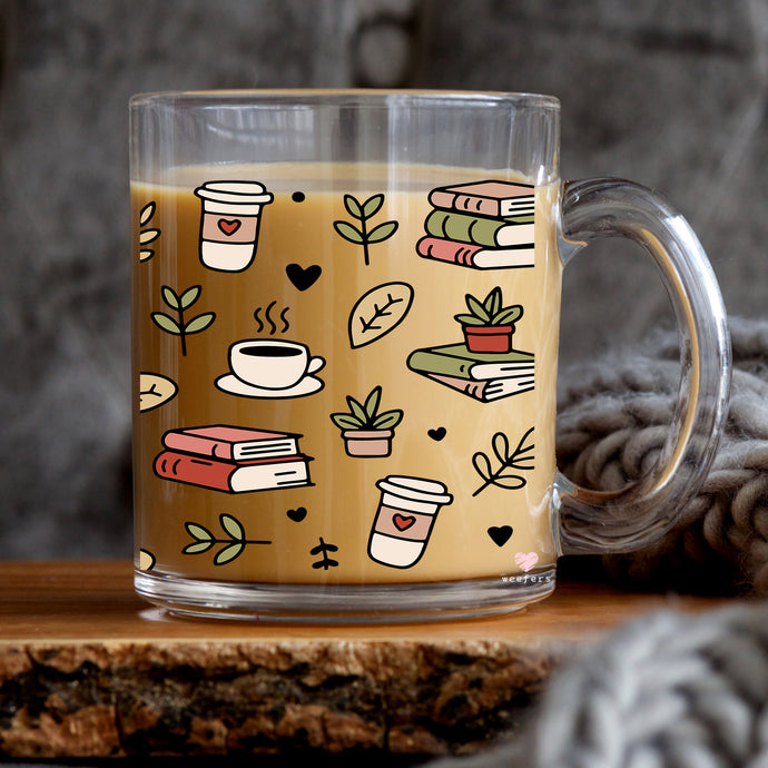 a glass mug filled with coffee and books