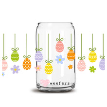Load image into Gallery viewer, a glass jar with a bunch of colorful eggs hanging from it
