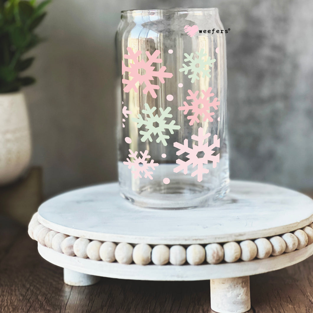 a glass jar with pink and white snowflakes on it