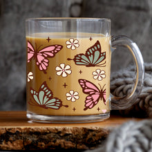 Load image into Gallery viewer, a glass mug with a pattern of butterflies on it
