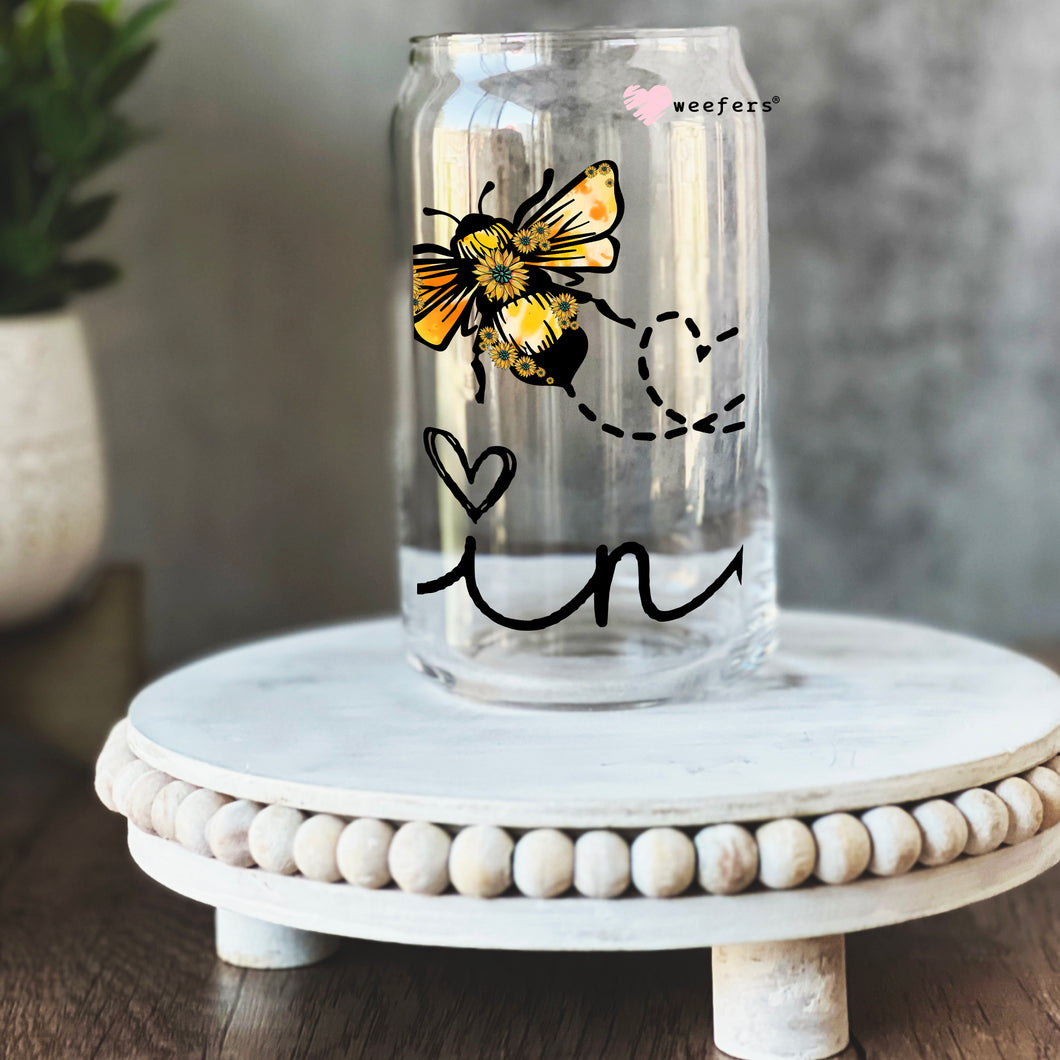 a glass jar with a drawing of a bee on it