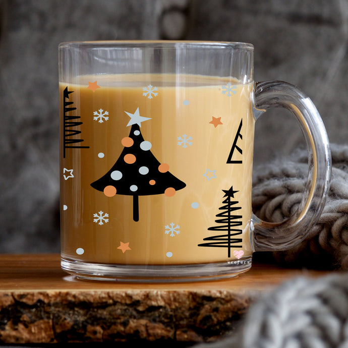a glass mug with a christmas tree on it