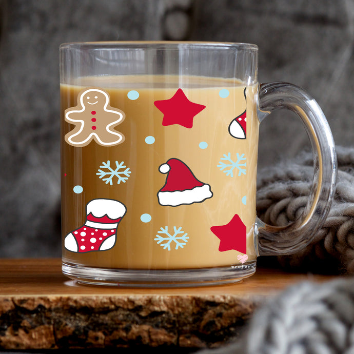 a glass mug with a gingerbread design on it