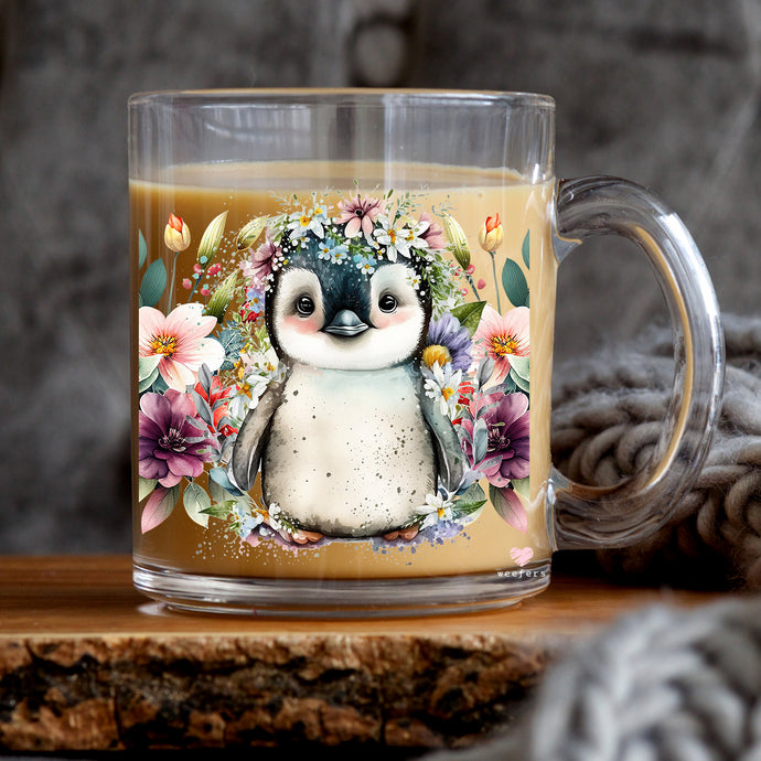a glass mug with a picture of a penguin on it