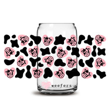 Load image into Gallery viewer, a glass jar filled with lots of pink and black skulls
