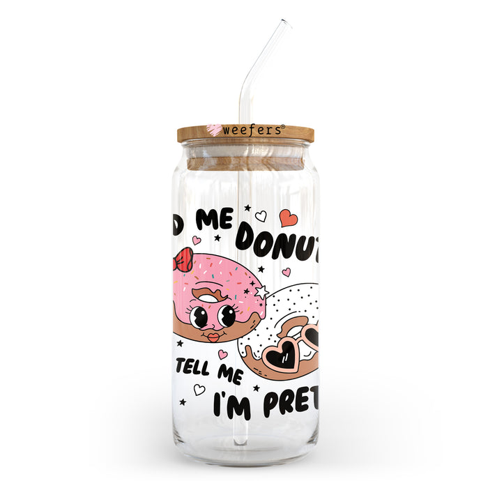 a glass jar with a straw in it with a donut on it