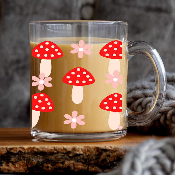 a glass mug with a mushroom design on it