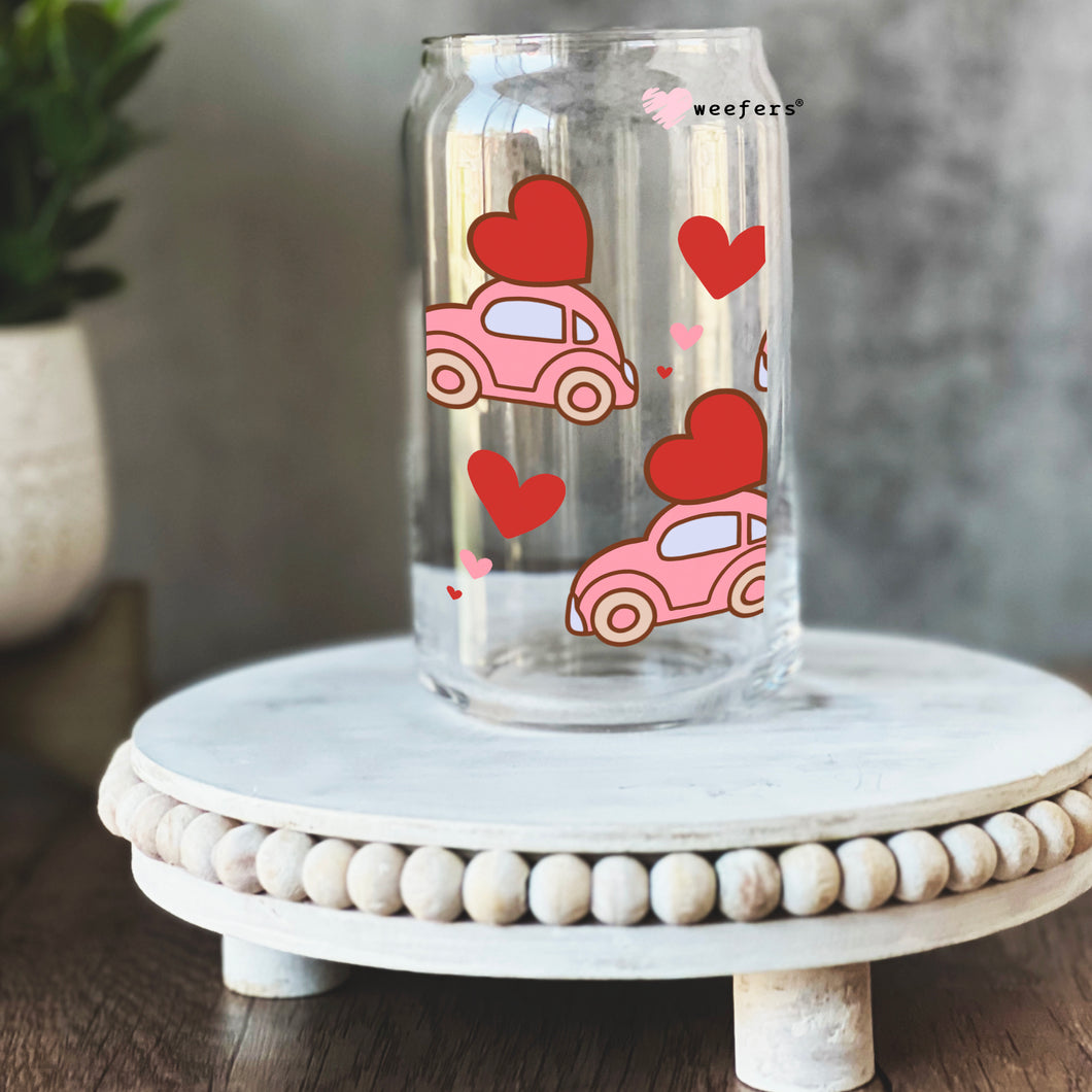 a glass jar with a pink car and hearts on it