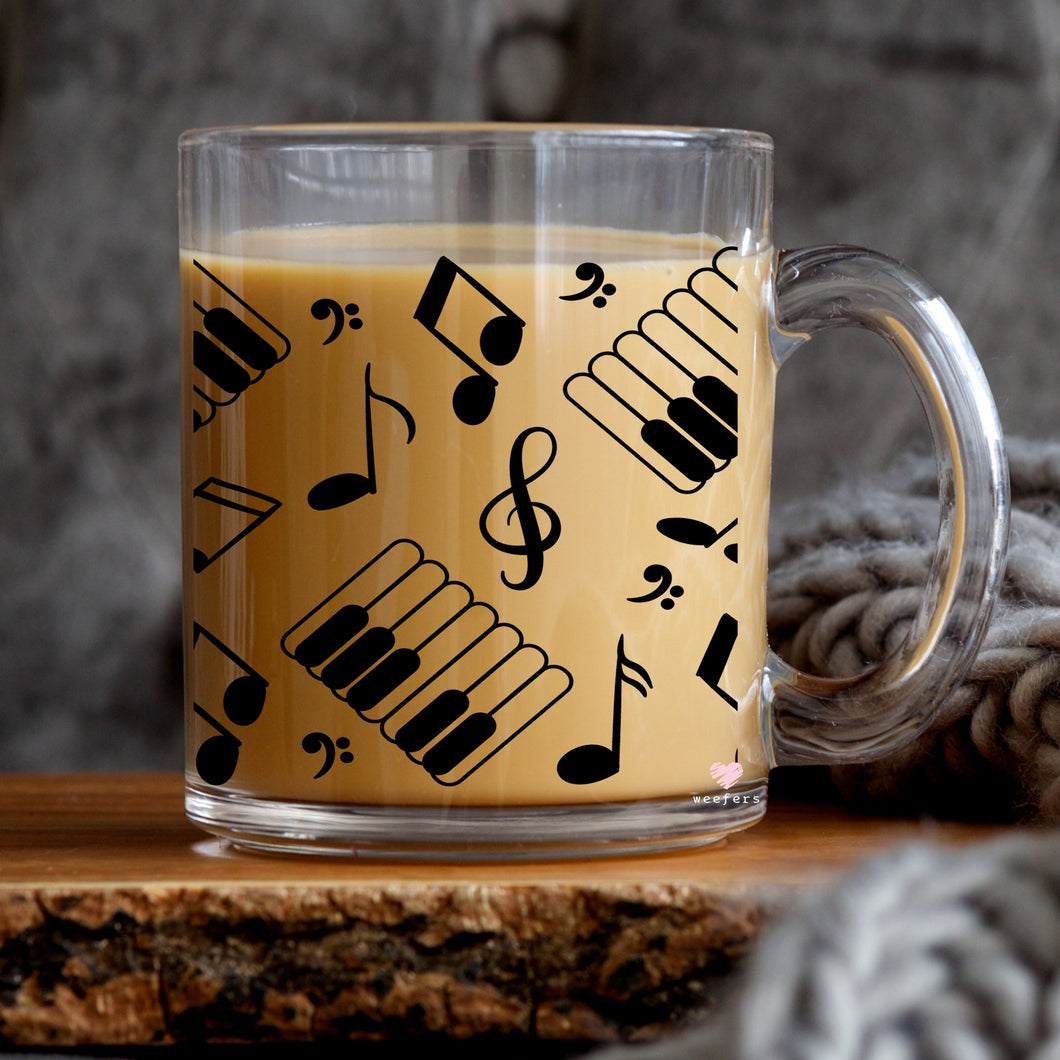 a glass mug with musical notes on it
