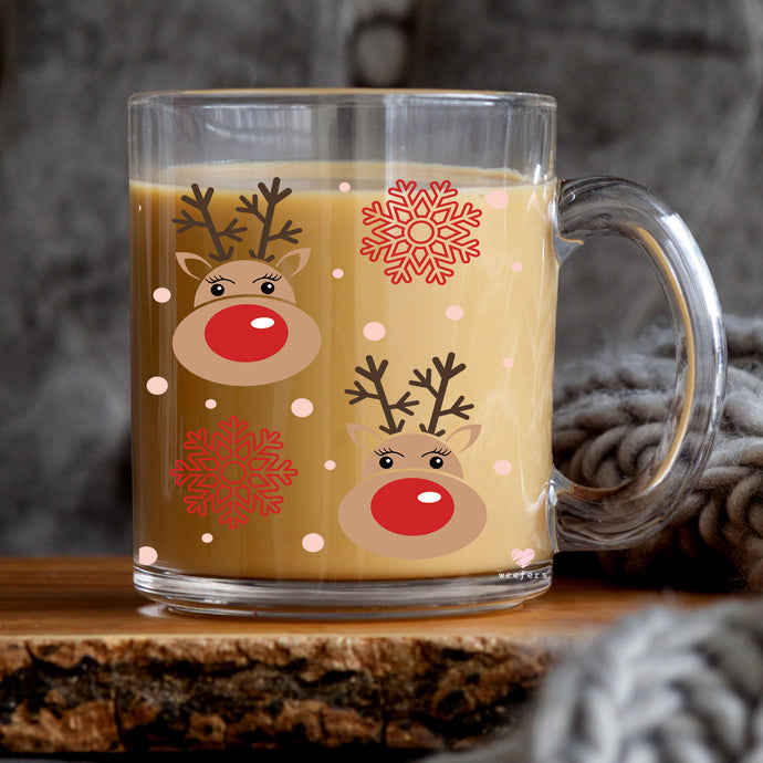 a glass mug with a reindeer design on it