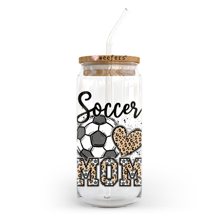 a glass jar with a straw in it that says soccer mom
