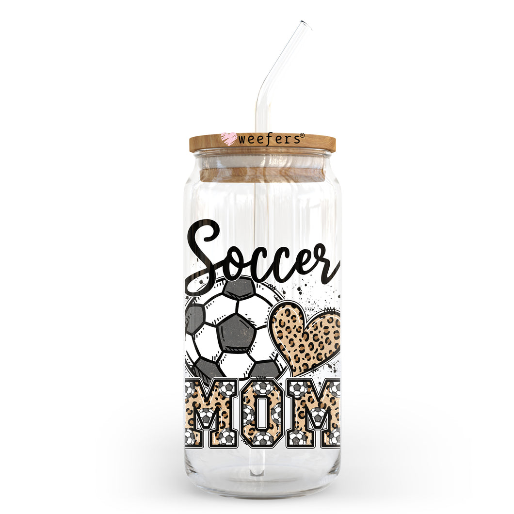 a glass jar with a straw in it that says soccer mom