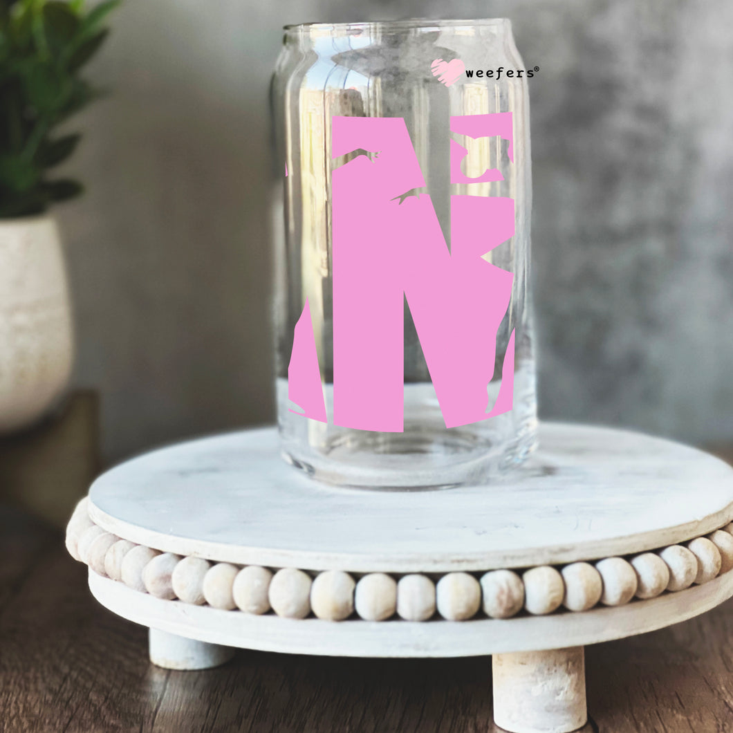 a glass jar with the letter n painted on it