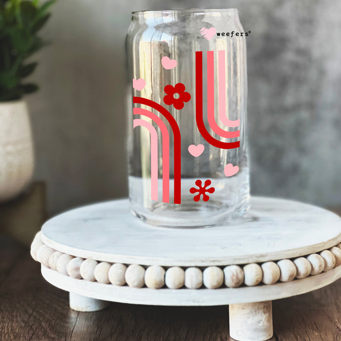 a glass jar with a red and white design on it