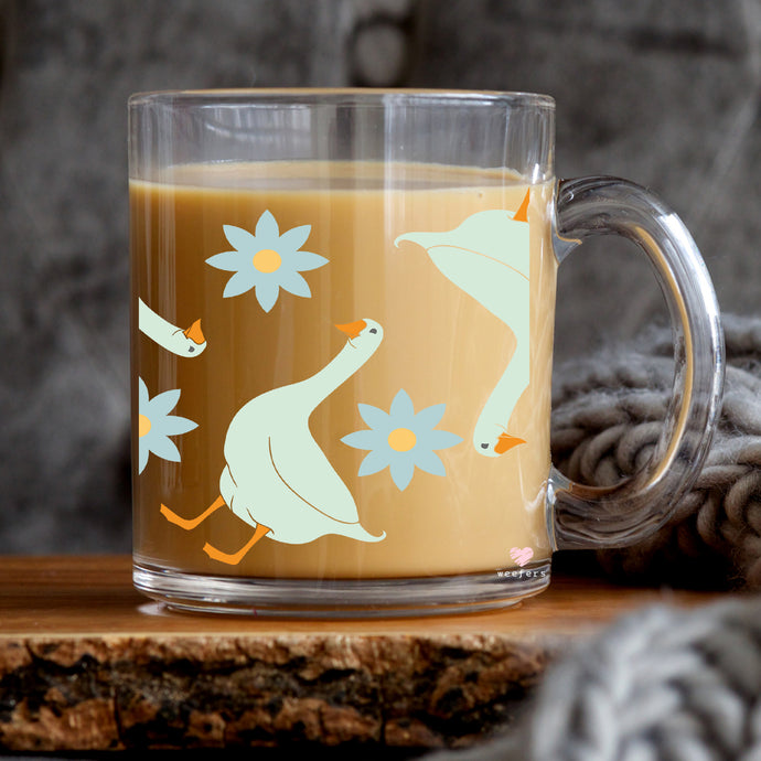 a glass mug with a bird design on it