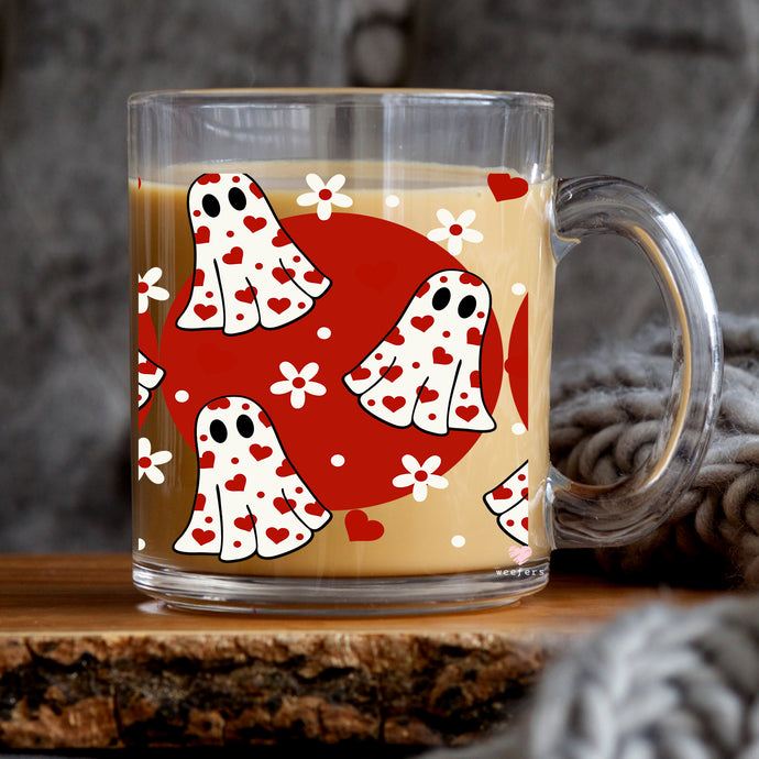 a glass mug with a red and white design on it