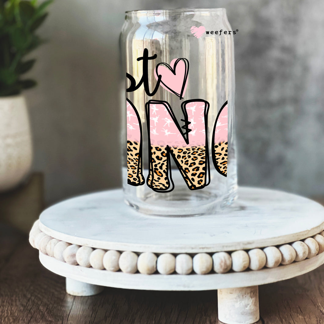 a glass jar with a pink and black design on it