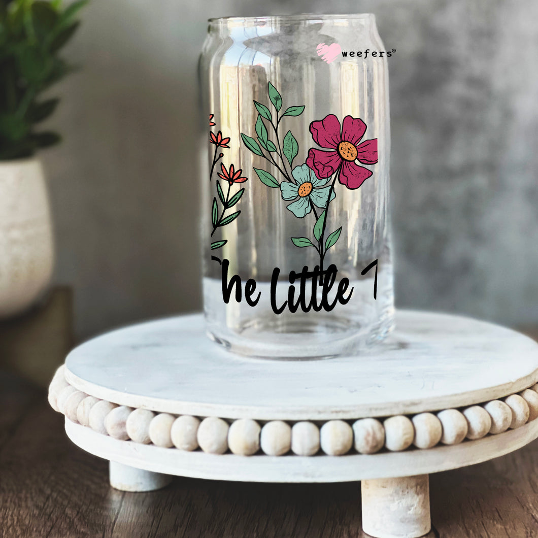 a glass jar with a flower design on it