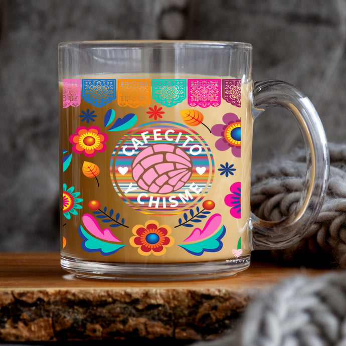 a glass mug with a colorful design on it